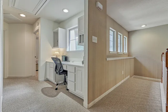 a view of a entryway with workspace and windows