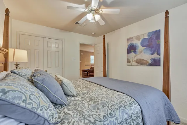 a bedroom with a large bed and a chandelier