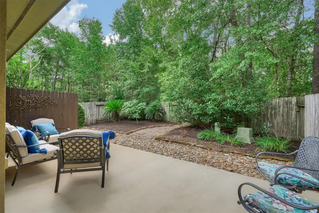 a view of a backyard with couches and a table and chairs