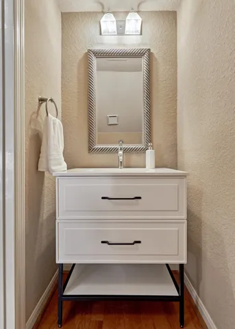 a bathroom with a sink a mirror and a vanity