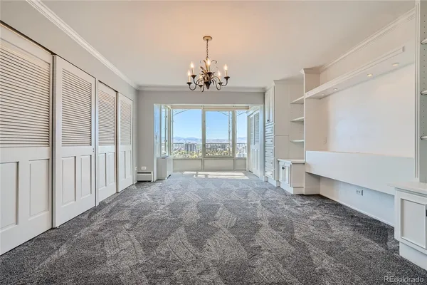 a large white kitchen with a sink and dishwasher a refrigerator with white cabinets
