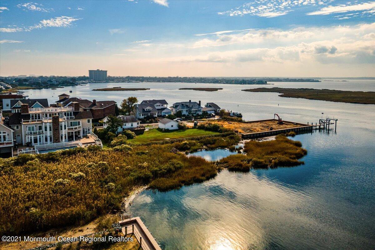 15 Riverview Road Monmouth Beach, NJ 07750 - Photo 12 of 38 a view of a lake with lawn chairs
