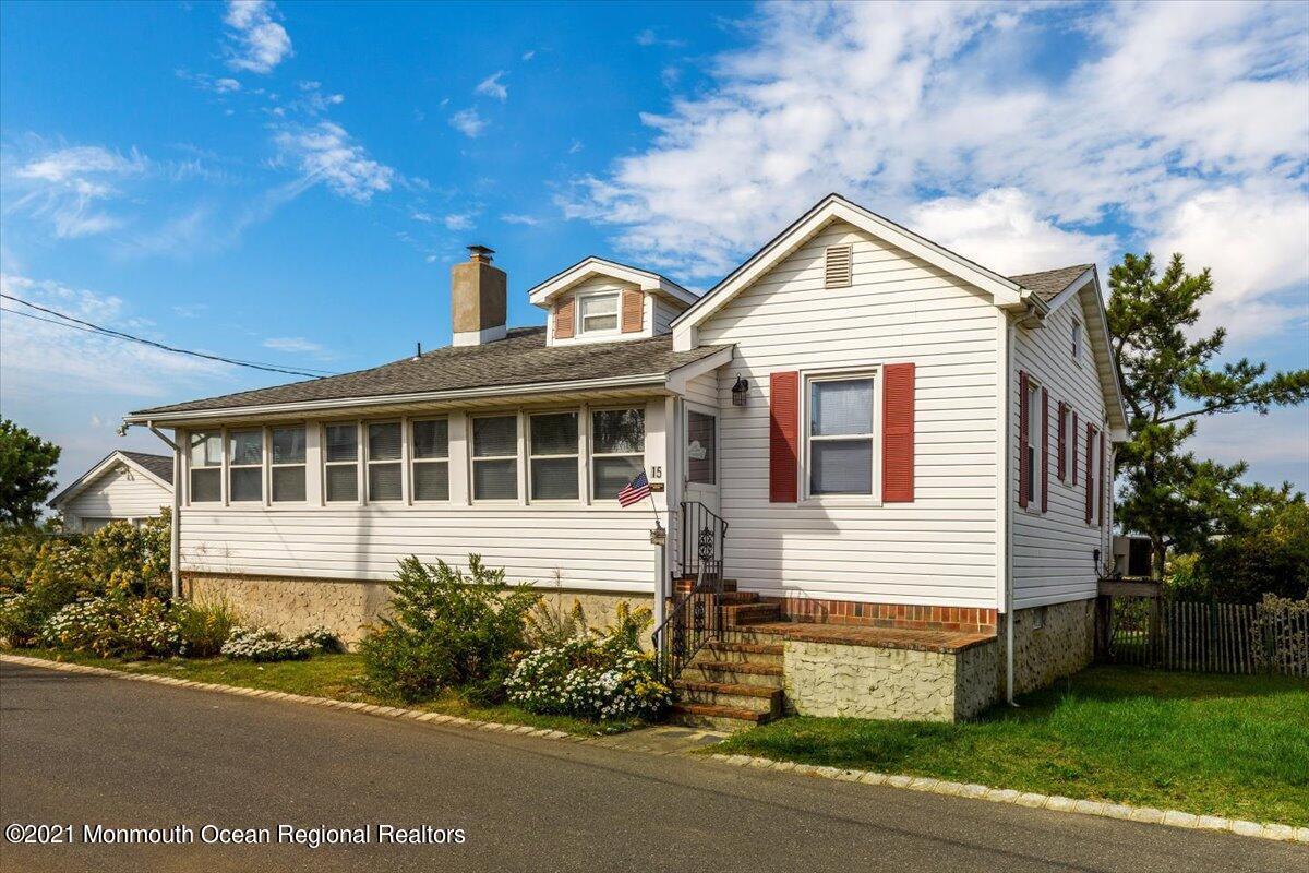 15 Riverview Road Monmouth Beach, NJ 07750 - Photo 14 of 38 a front view of a house with a yard and garage