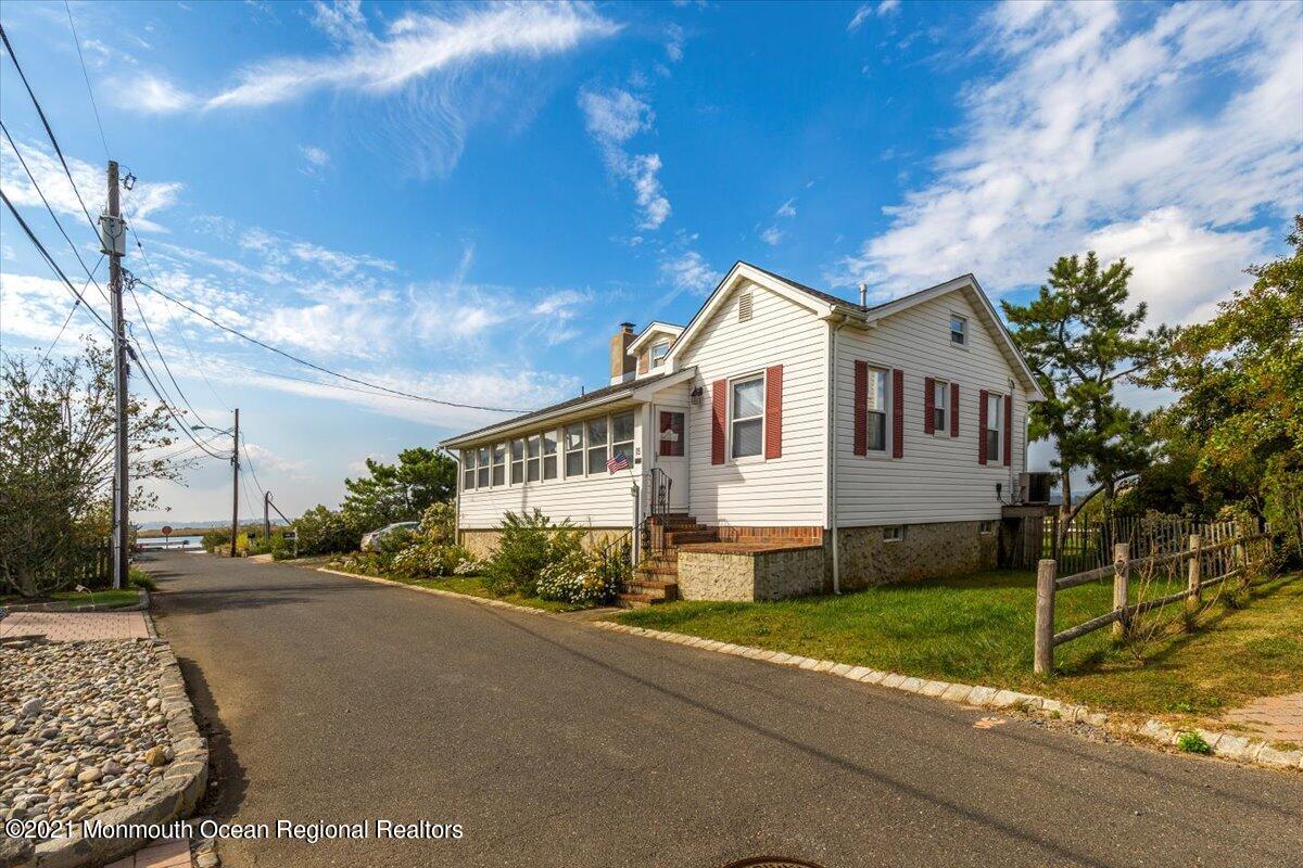15 Riverview Road Monmouth Beach, NJ 07750 - Photo 15 of 38 a front view of a house with a garden and trees