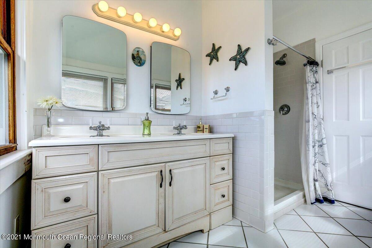 15 Riverview Road Monmouth Beach, NJ 07750 - Photo 6 of 38 a bathroom with a sink vanity and a mirror