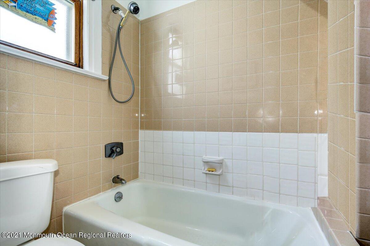 15 Riverview Road Monmouth Beach, NJ 07750 - Photo 8 of 38 a bathroom with a tub a toilet and a shower
