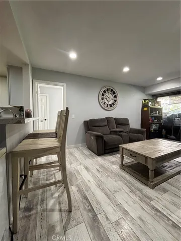 a living room with furniture a rug and white walls