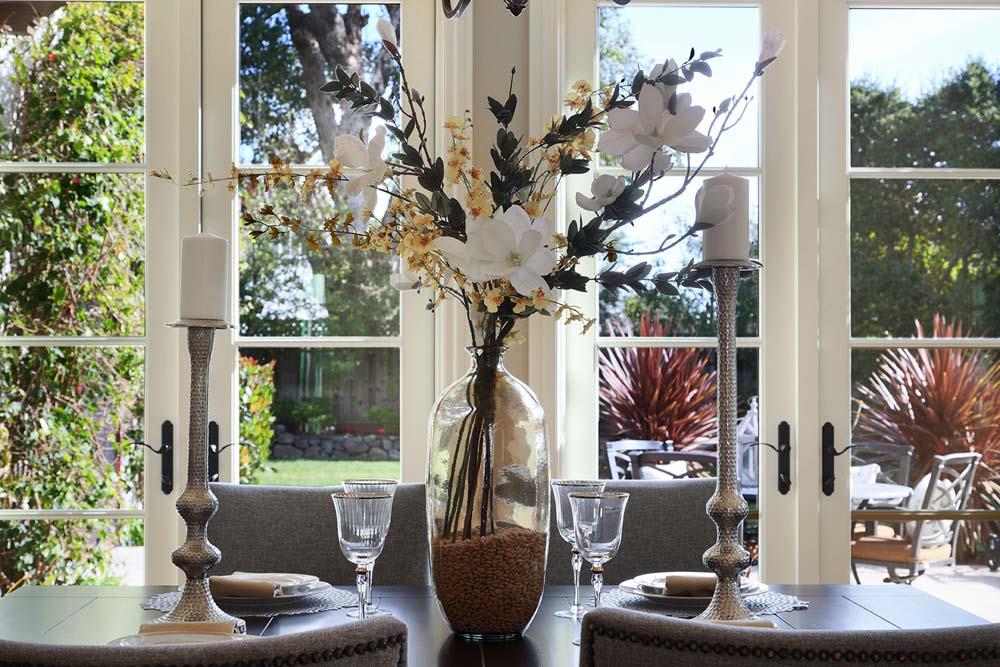 150 Newton Drive Burlingame, CA 94010 - Photo 23 of 58 a vase of flowers sitting on a table with a potted plant