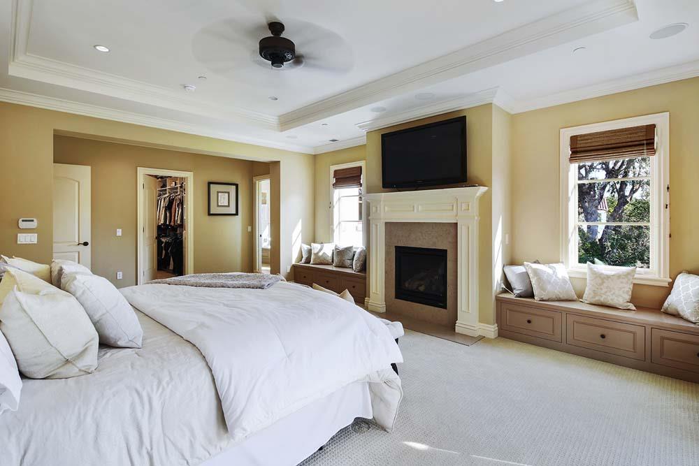 150 Newton Drive Burlingame, CA 94010 - Photo 31 of 58 a spacious bedroom with a large bed and a fireplace