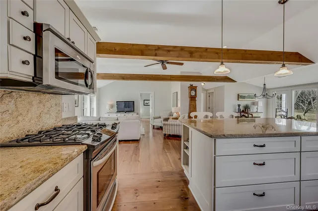 a kitchen with stove and cabinets