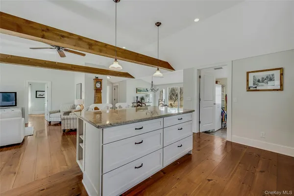 a kitchen with granite countertop white cabinets and stainless steel appliances
