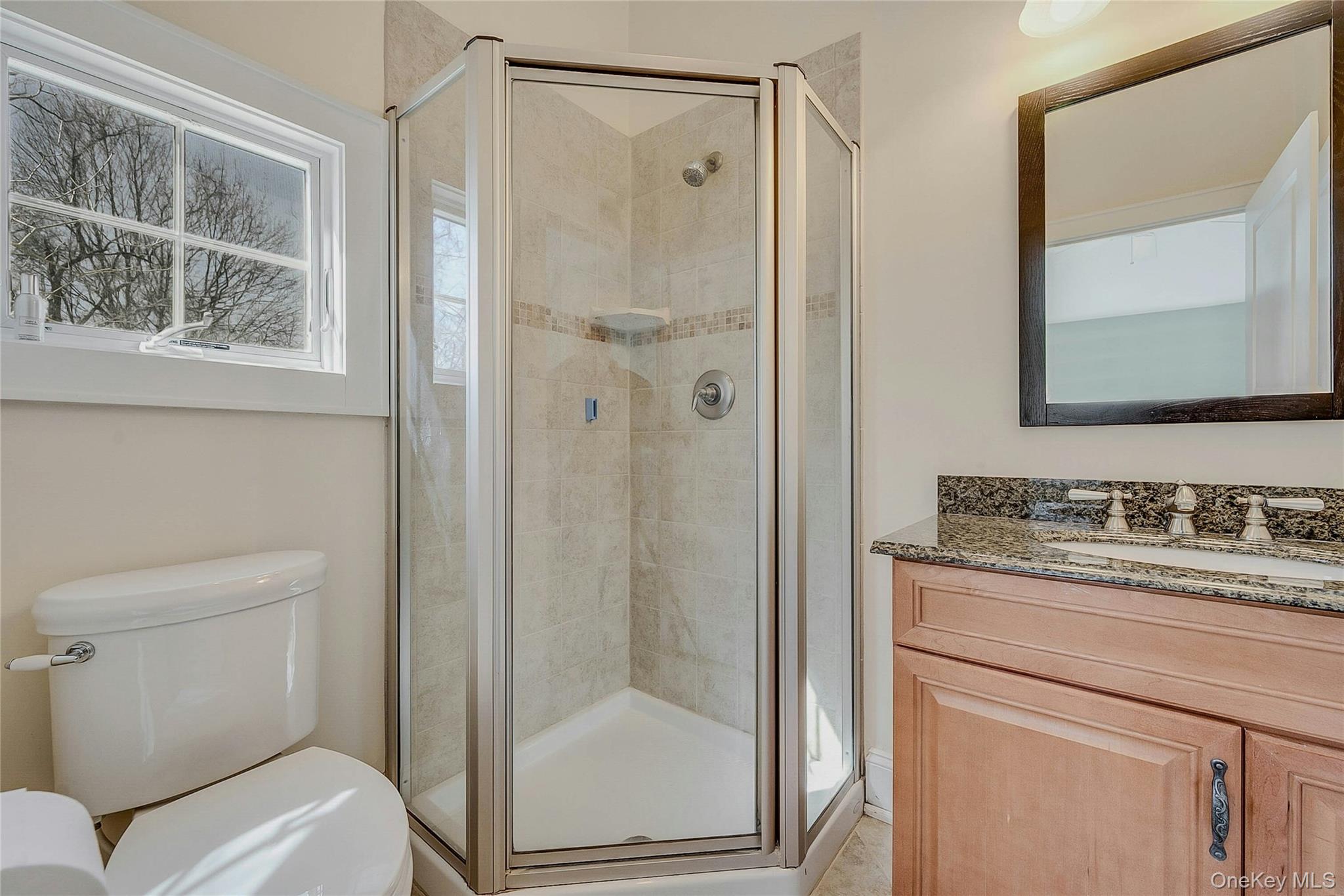 635 Strohson Road Cutchogue, NY 11935 - Photo 19 of 32 a bathroom with a granite countertop sink toilet and shower