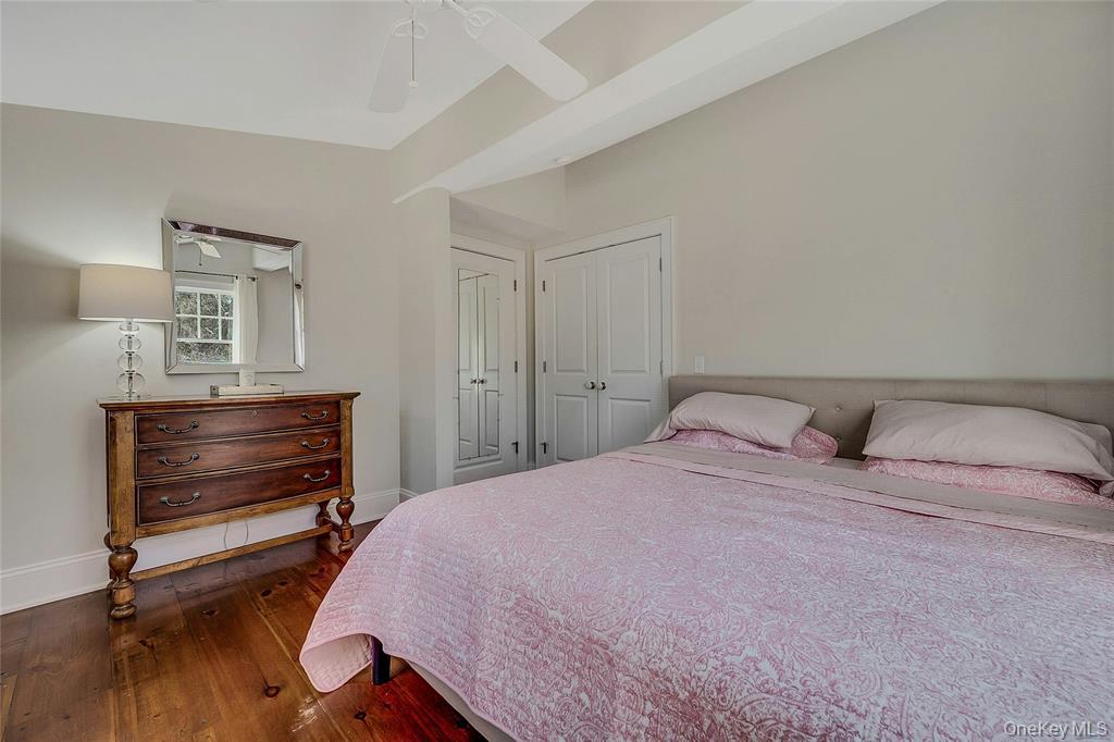 635 Strohson Road Cutchogue, NY 11935 - Photo 21 of 32 a bedroom with a bed and a dresser