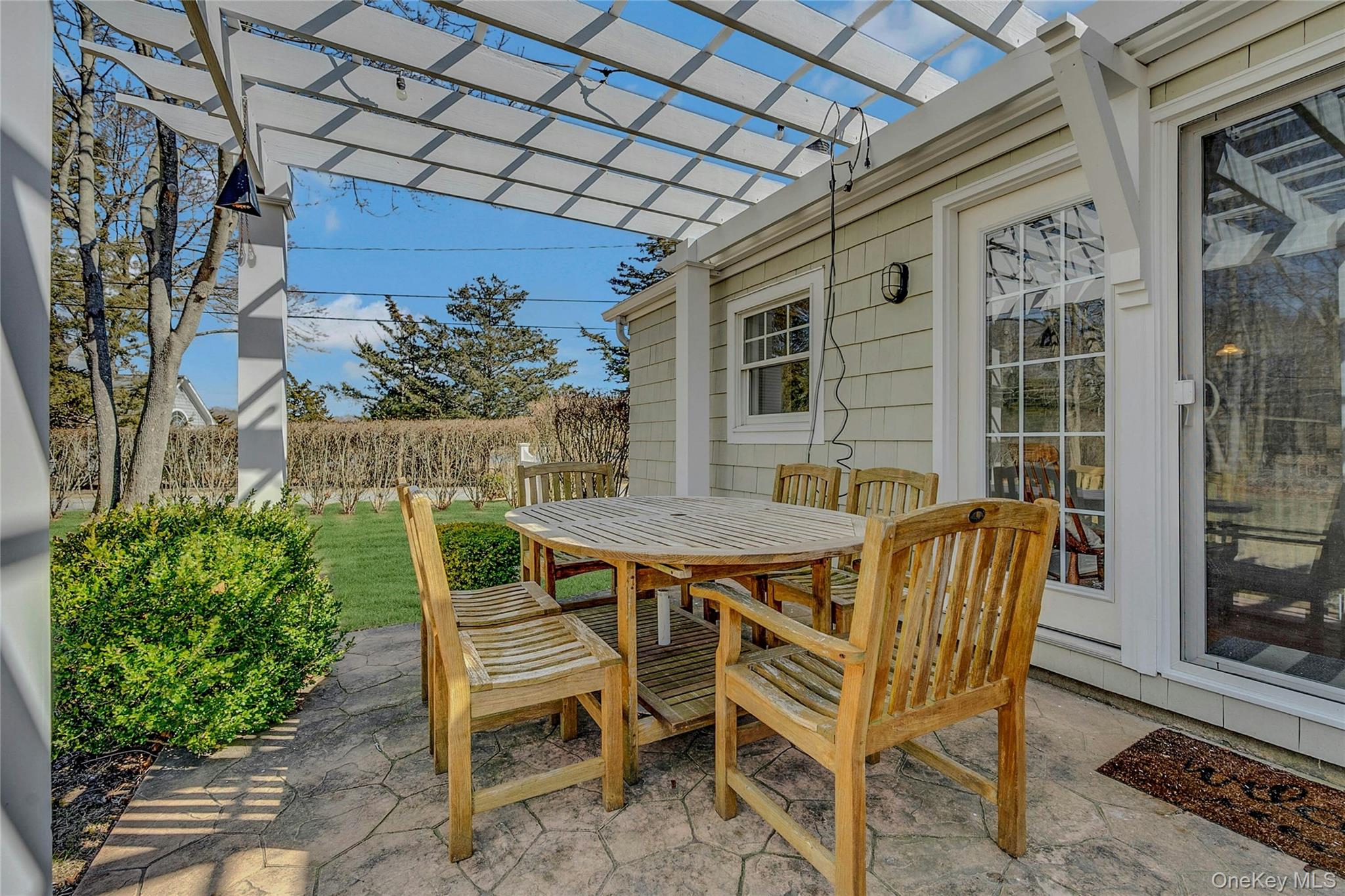 635 Strohson Road Cutchogue, NY 11935 - Photo 26 of 32 a patio with table and chairs and potted plants