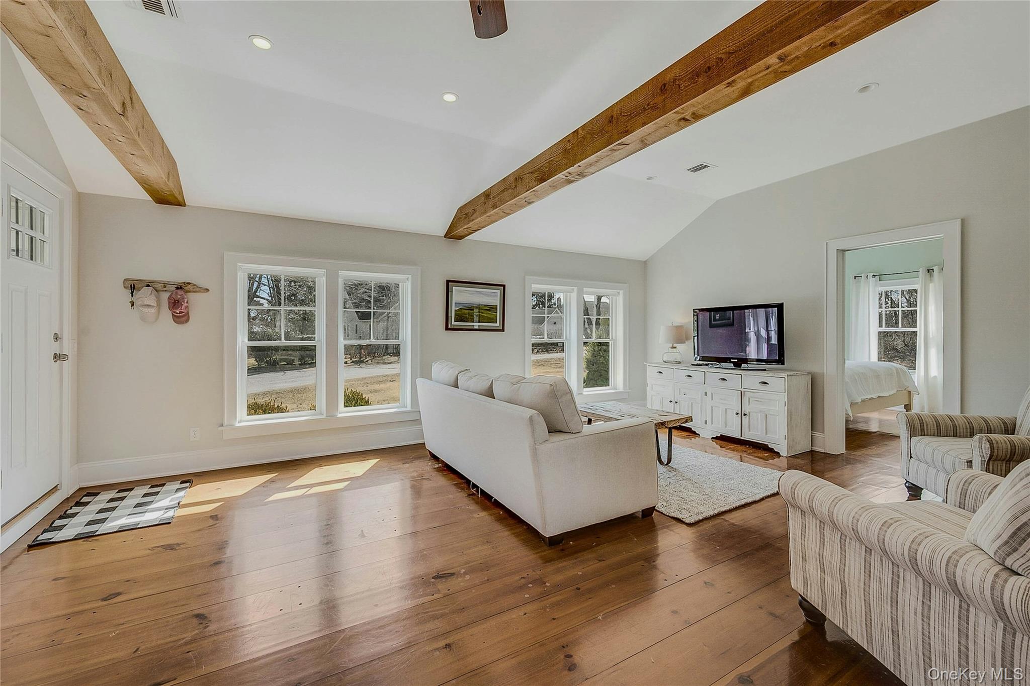 635 Strohson Road Cutchogue, NY 11935 - Photo 4 of 32 a living room with furniture and a flat screen tv