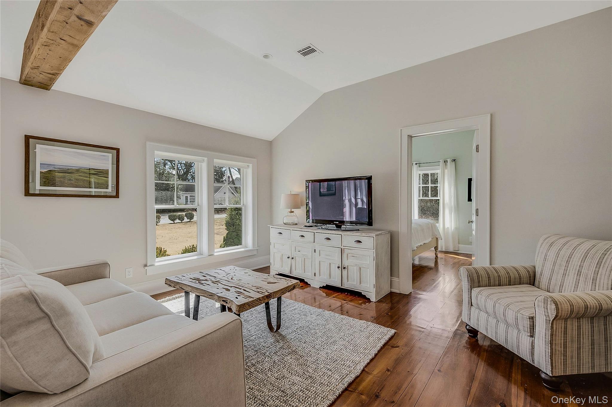 635 Strohson Road Cutchogue, NY 11935 - Photo 5 of 32 a living room with furniture and a flat screen tv