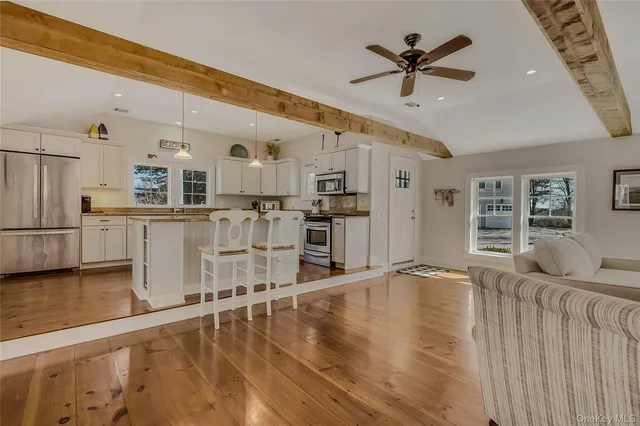 a living room with stainless steel appliances kitchen island granite countertop furniture and a kitchen view