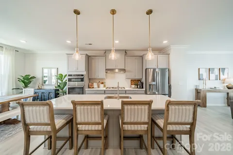 a dining room with furniture and a kitchen view