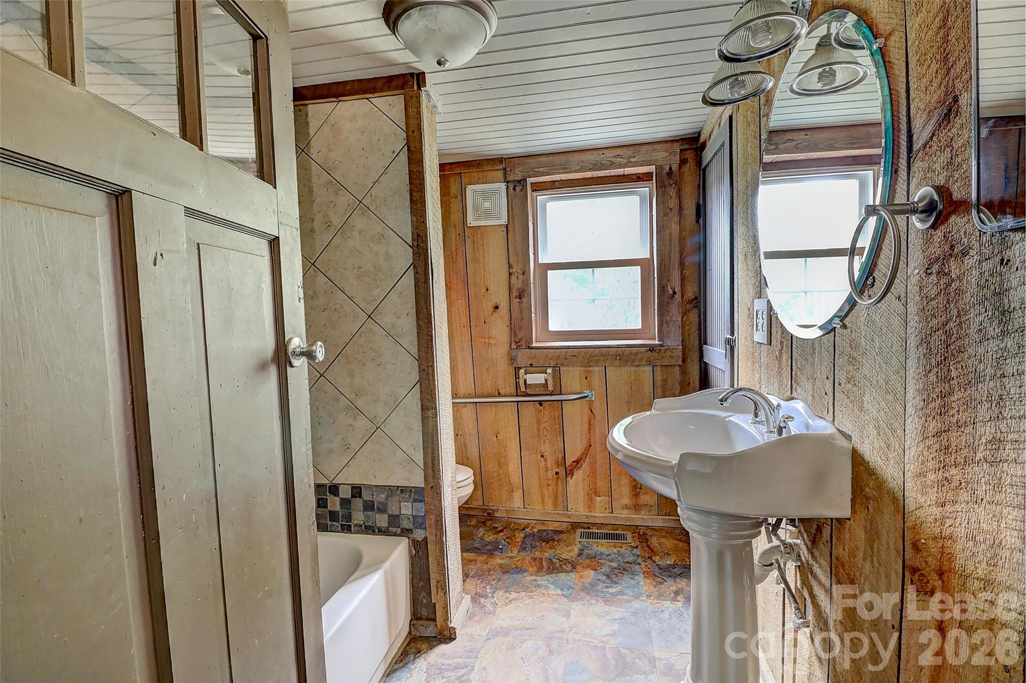 3601 Kidd Lane Charlotte, NC 28216 - Photo 11 of 19 a bathroom with a sink a mirror and a shower