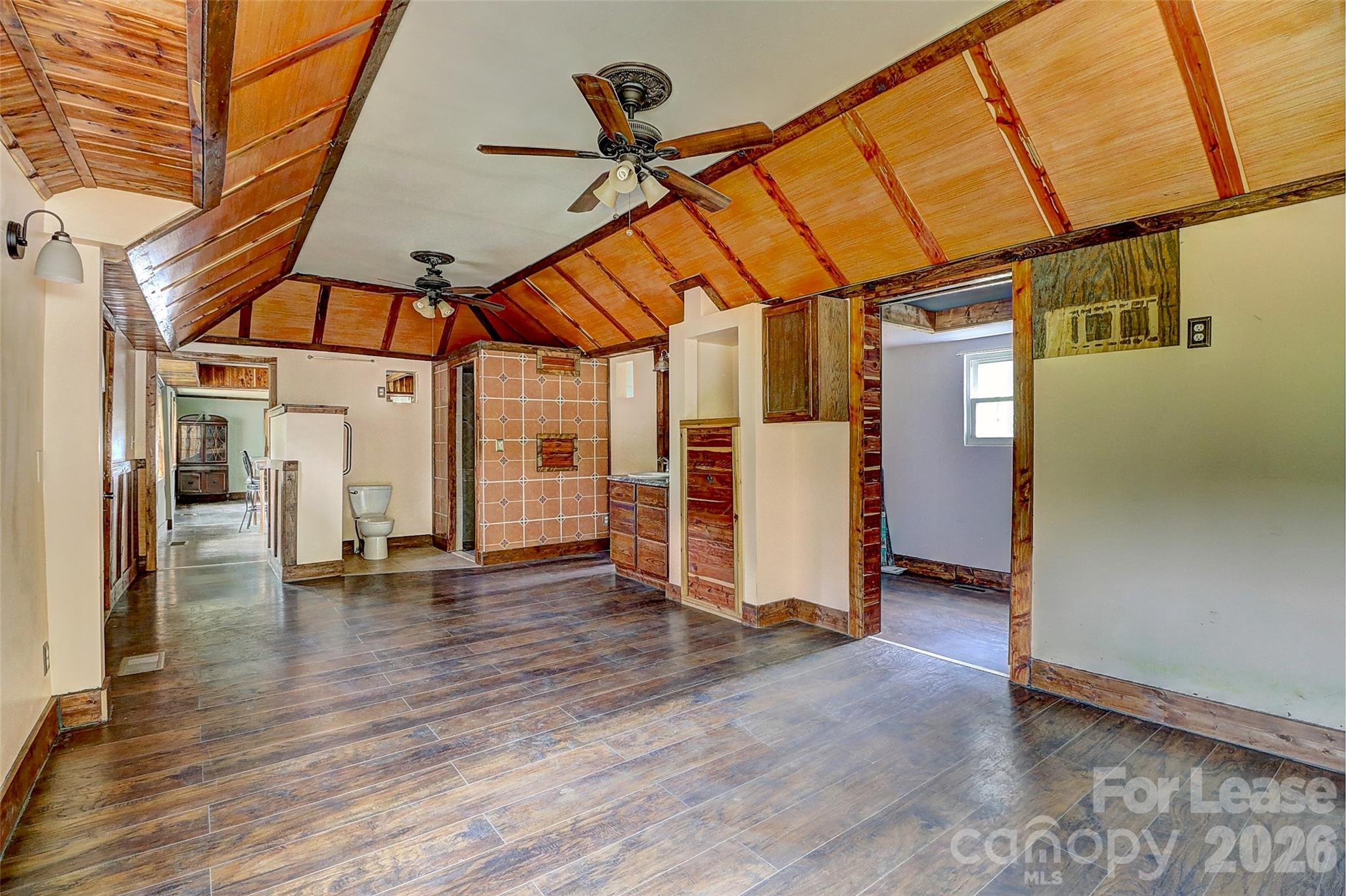 3601 Kidd Lane Charlotte, NC 28216 - Photo 8 of 19 an empty room with wooden floor and a ceiling fan