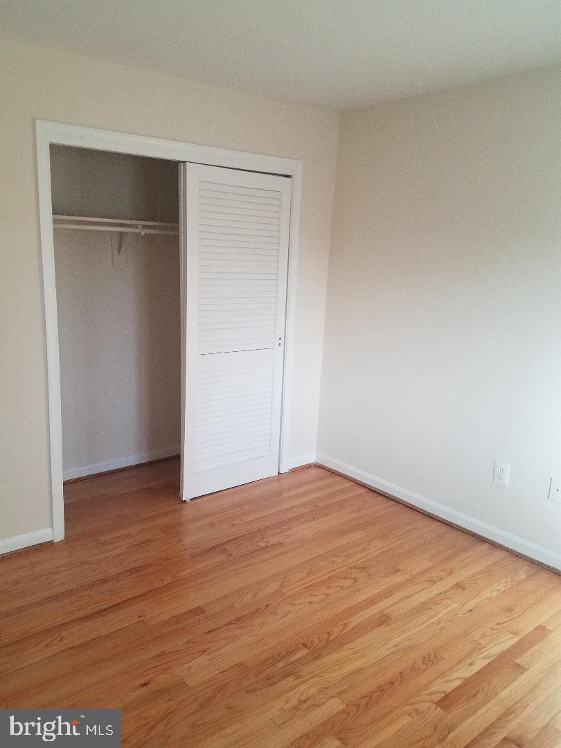 1152 Wimbledon Drive McLean, VA 22101 - Photo 26 of 37 a view of an empty room with wooden floor and closet