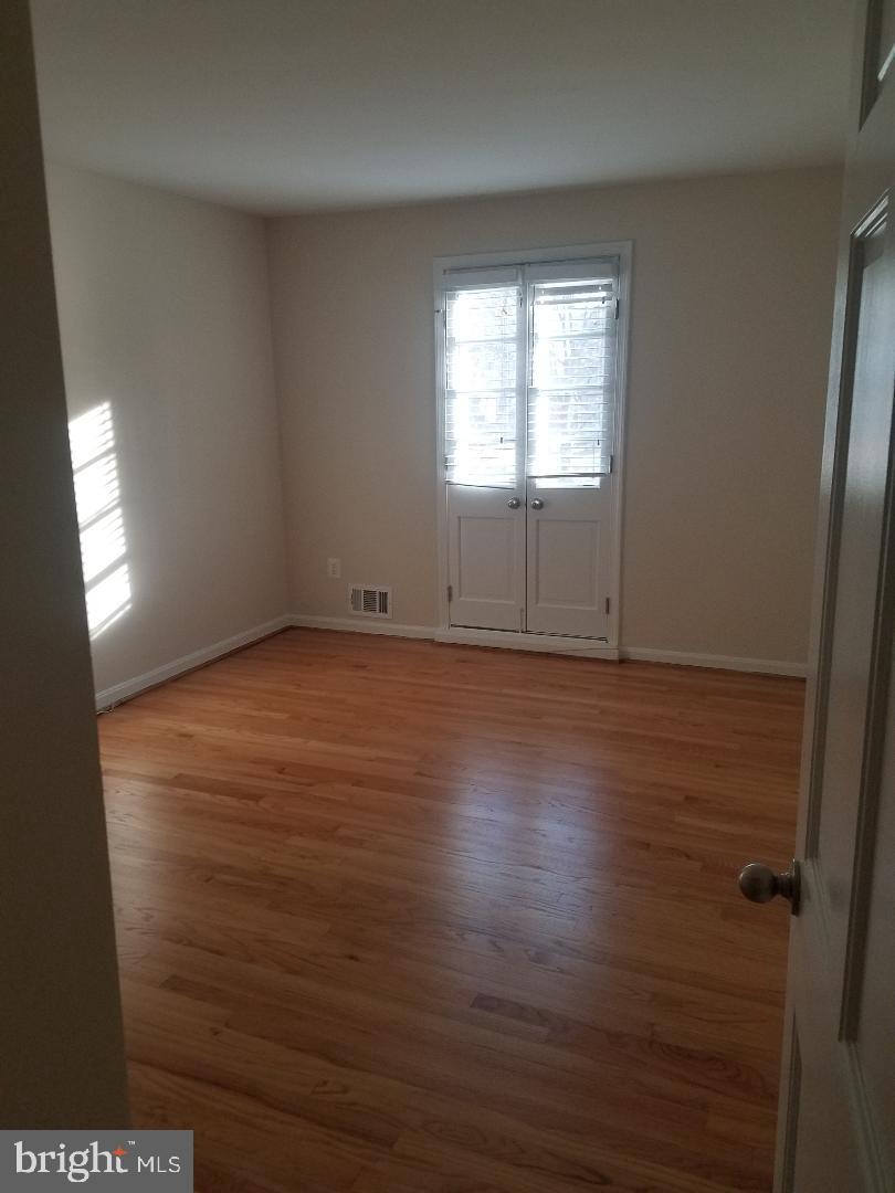 1152 Wimbledon Drive McLean, VA 22101 - Photo 27 of 37 an empty room with wooden floor and windows
