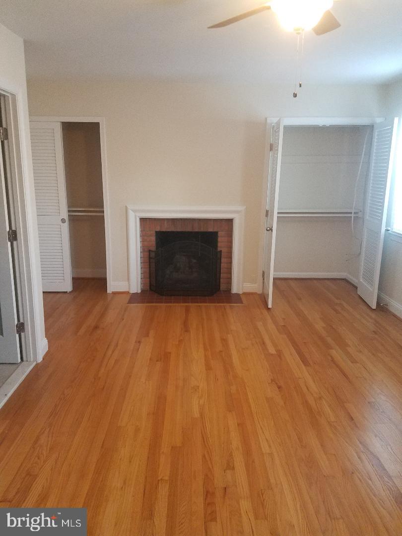 1152 Wimbledon Drive McLean, VA 22101 - Photo 31 of 37 a view of empty room with wooden floor and fireplace