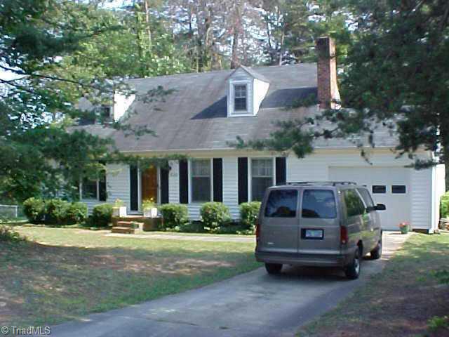 830 Bundaberg Lane Rural Hall, NC 27045 - Photo 1 of 9 Exterior Front. House has attached one-car garage and sets among mature trees that provide privacy from the neighbors.