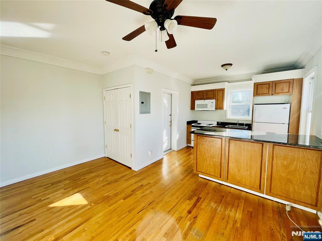 229 Orient Way, Unit 6 Rutherford, NJ 07070 - Photo 6 of 8 a view of a kitchen with wooden floor a ceiling fan and windows