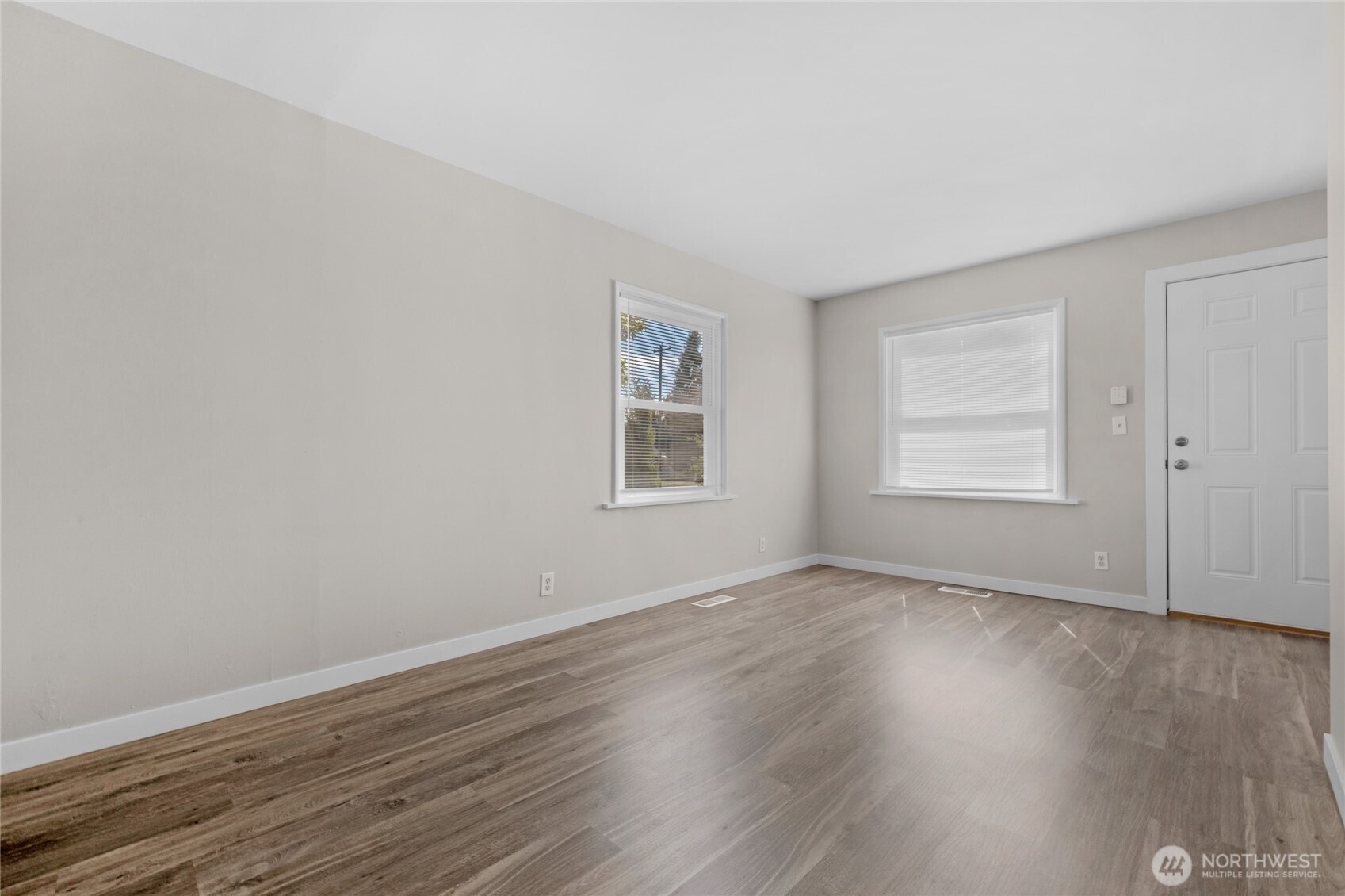 1925 Lombard Avenue, Unit A Everett, WA 98201 - Photo 14 of 25 a view of an empty room with wooden floor and a window