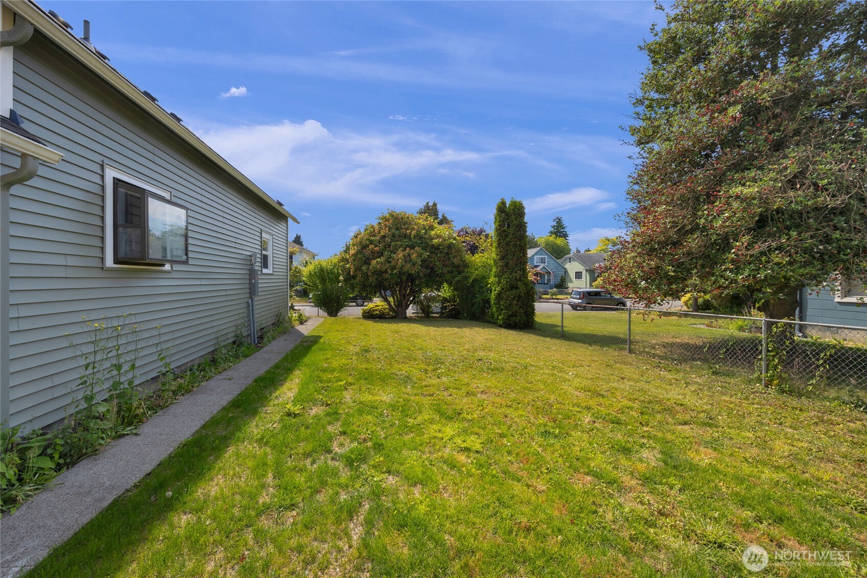 1925 Lombard Avenue, Unit A Everett, WA 98201 - Photo 22 of 25 a view of a backyard with large trees