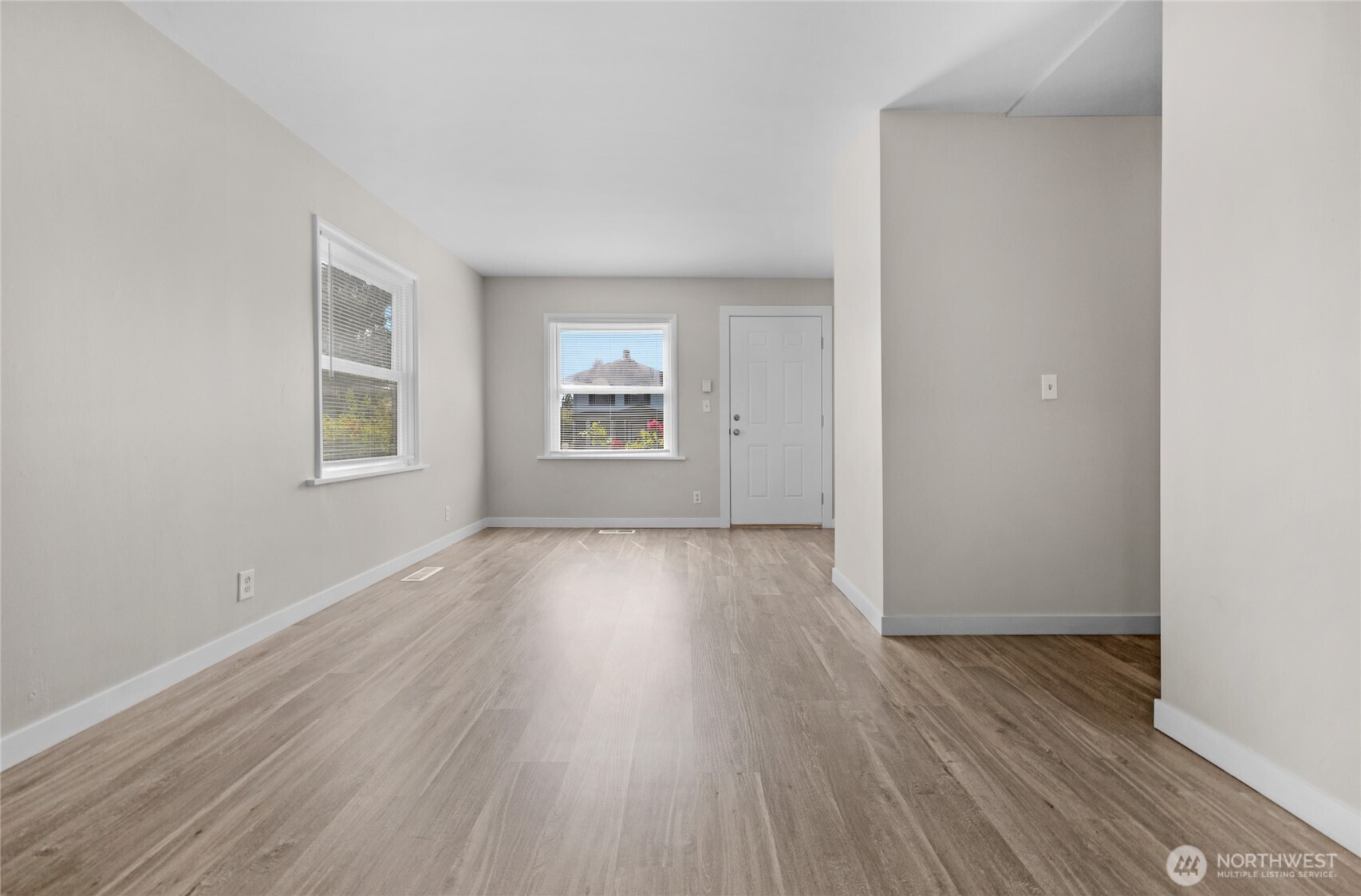 1925 Lombard Avenue, Unit A Everett, WA 98201 - Photo 8 of 25 an empty room with wooden floor and windows