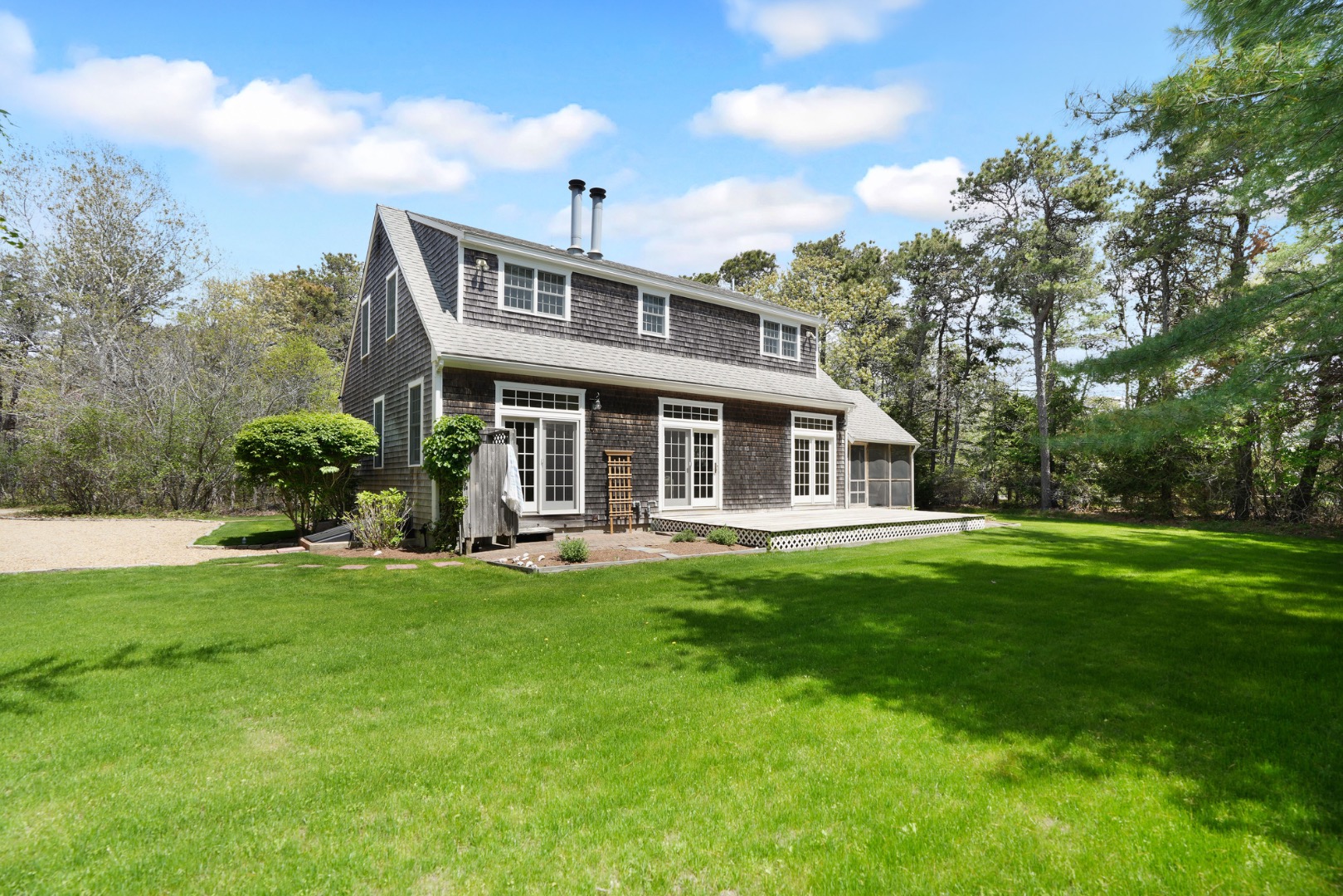 2 Cosmos Way Edgartown, MA 02539 - Photo 3 of 29 a front view of a house with a garden