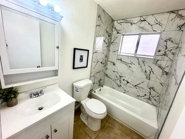 a bathroom with a toilet and a bathtub