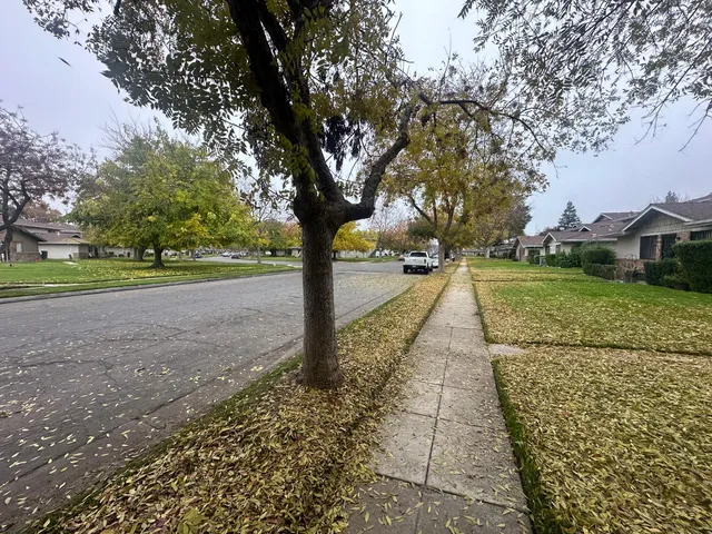 a view of a swimming pool with a yard and a lake view