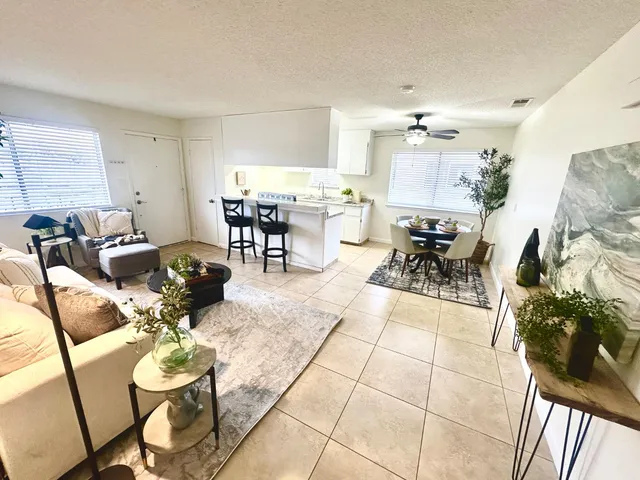 a living room with furniture and wooden floor