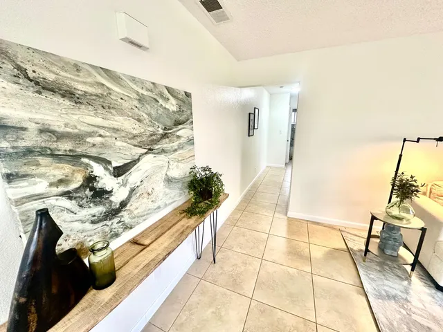 a dining room with chandelier and window