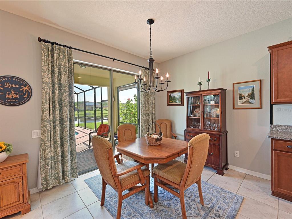 9716 58th Street East Parrish, FL 34219 - Photo 15 of 58 a dining room with furniture a chandelier and window