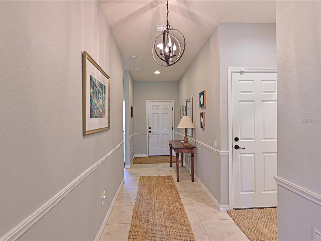 9716 58th Street East Parrish, FL 34219 - Photo 16 of 58 a view of a hallway with entryway wooden floor and front door