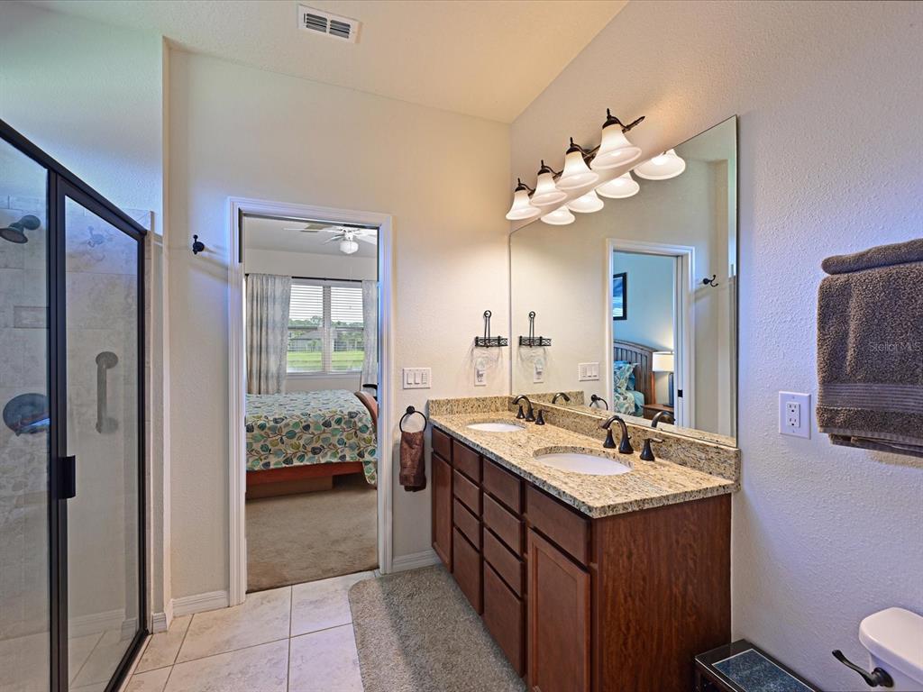 9716 58th Street East Parrish, FL 34219 - Photo 20 of 58 a bathroom with a sink vanity and a mirror