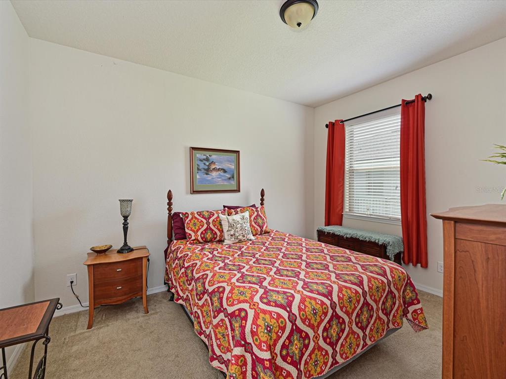 9716 58th Street East Parrish, FL 34219 - Photo 24 of 58 a bedroom with a bed and a window