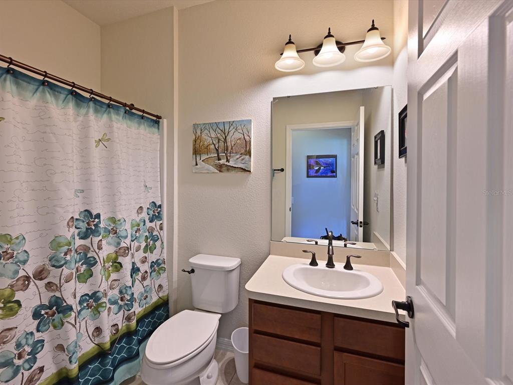 9716 58th Street East Parrish, FL 34219 - Photo 25 of 58 a bathroom with a sink toilet and mirror