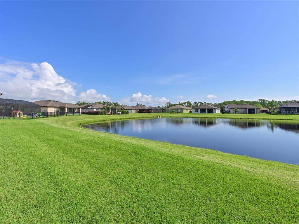 9716 58th Street East Parrish, FL 34219 - Photo 33 of 58 a view of a lake with houses in the background