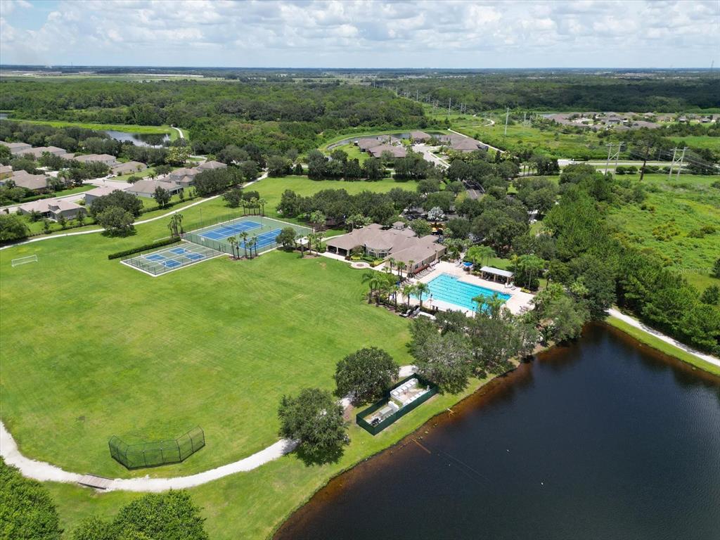 9716 58th Street East Parrish, FL 34219 - Photo 51 of 58 an aerial view of residential houses with outdoor space and trees
