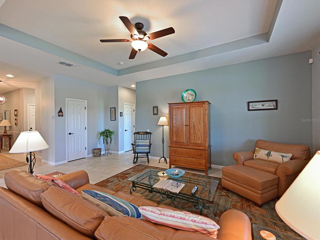 9716 58th Street East Parrish, FL 34219 - Photo 9 of 58 a living room with furniture and a lamp