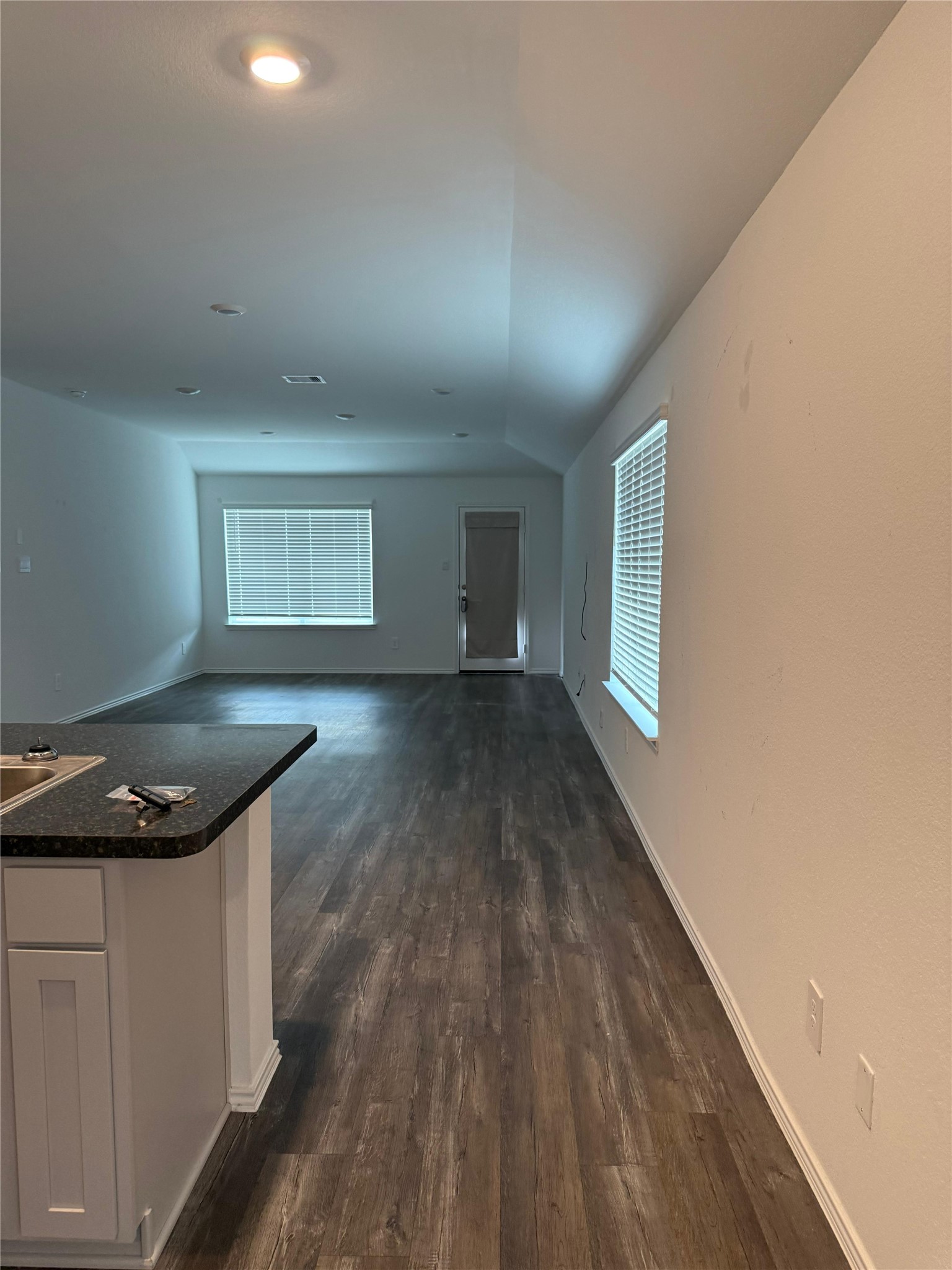 6007 Diamond Vista Court Spring, TX 77373 - Photo 6 of 24 a kitchen with wooden floor and white walls