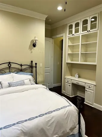 a bedroom with a bed and a desk