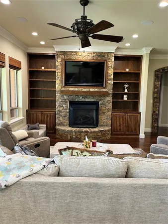 a living room with fireplace furniture and a flat screen tv