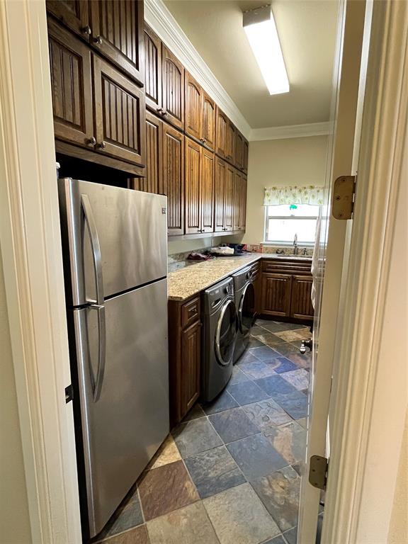 1255 County Road 3400 Emory, TX 75440 - Photo 24 of 36 a kitchen with granite countertop a refrigerator and a stove top oven
