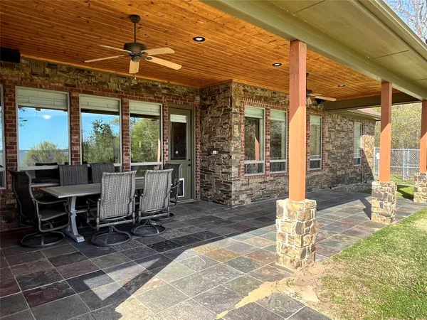a view of a patio with a dining table and chairs